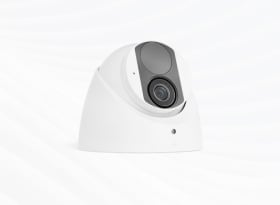 White dome security camera with dark tinted lens on white background