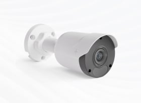 White and gray bullet security camera mounted on wall bracket