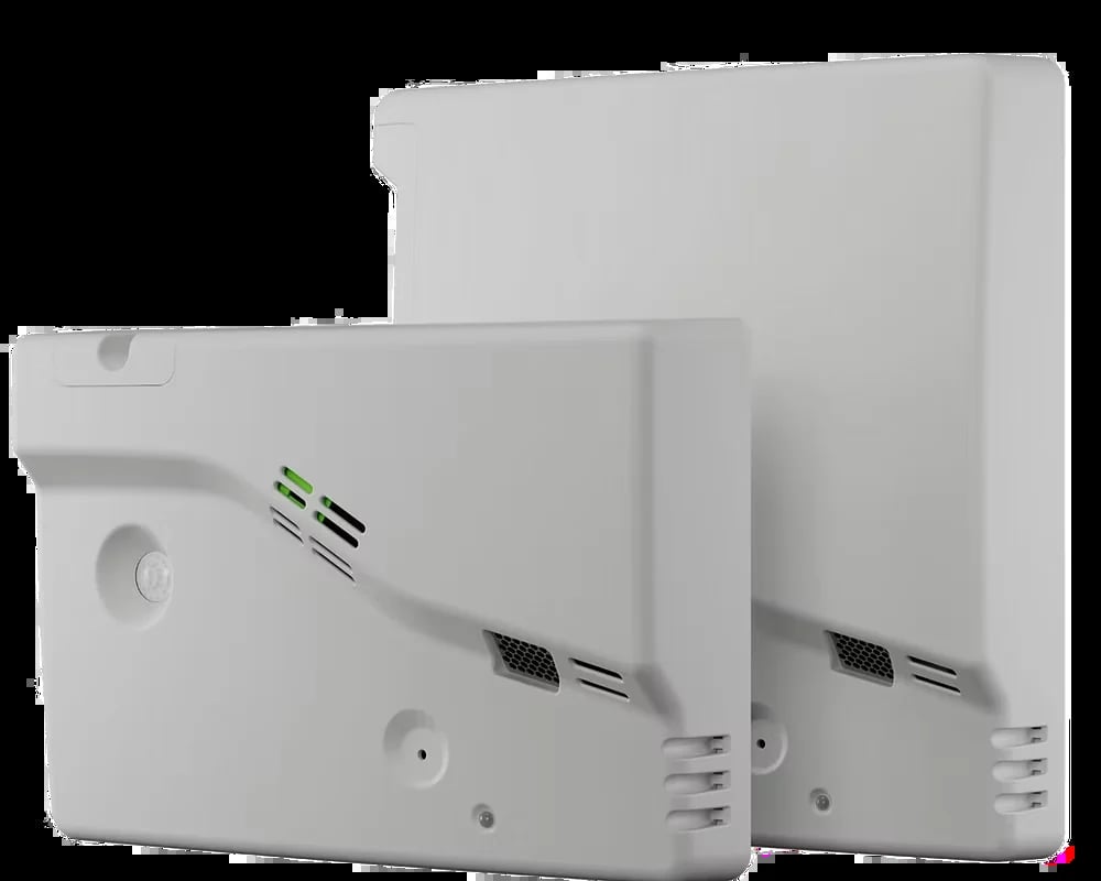 Two white wall-mounted electric heating units with thermostat displays and ventilation slots