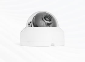 White dome security camera with gray spherical lens housing on light background